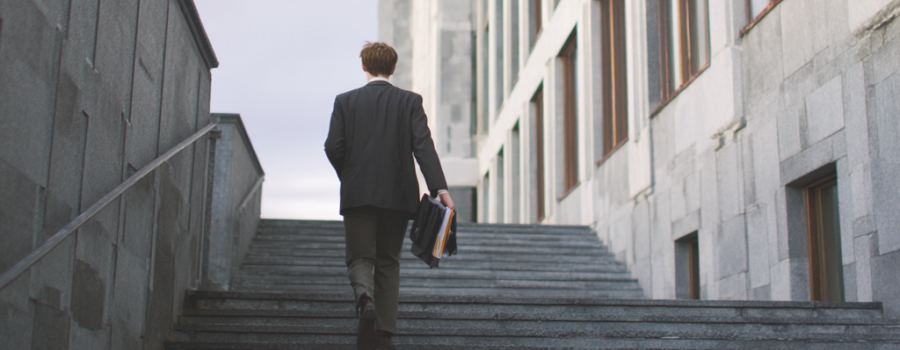 young proffesional walking up stairs